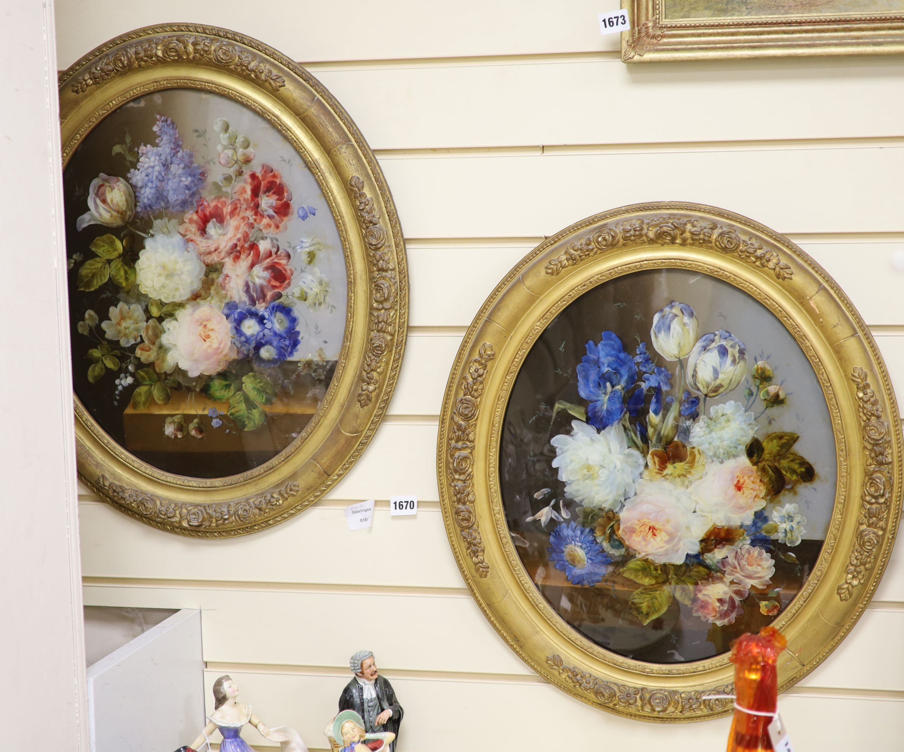 A pair of Victorian reverse painted oval glass flower paintings, 45 x 37cm.